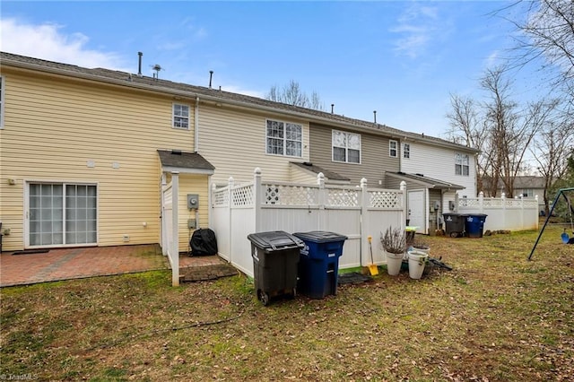 rear view of property featuring a yard and a patio