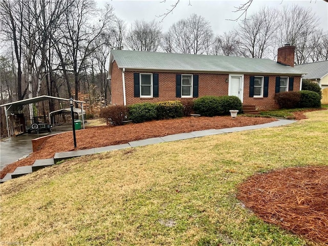 view of front facade with a carport and a front lawn