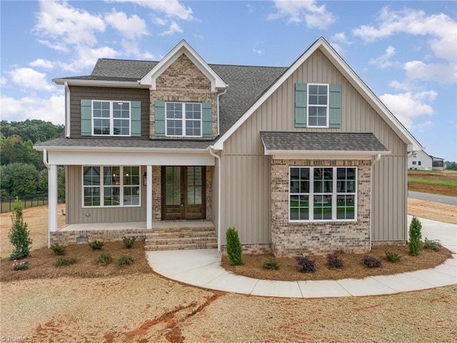 craftsman-style house featuring a porch and french doors