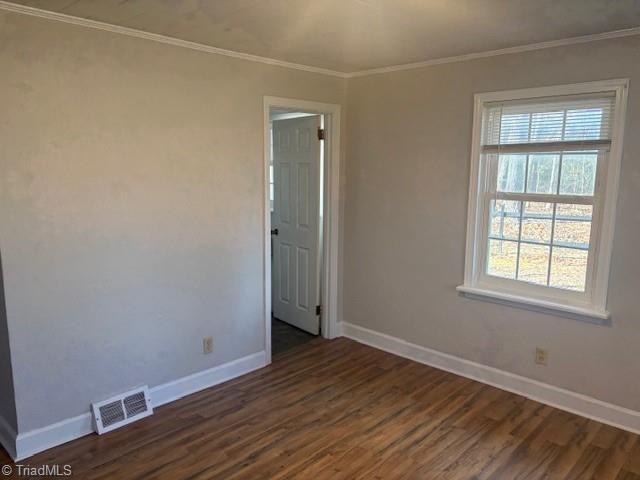 unfurnished room featuring crown molding and dark hardwood / wood-style floors