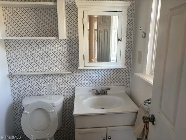 bathroom with vanity and toilet