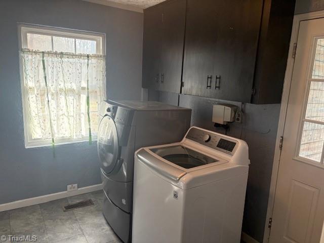 clothes washing area with independent washer and dryer