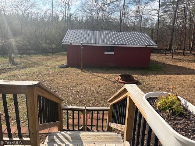 wooden terrace featuring an outbuilding