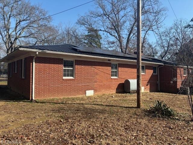 view of property exterior featuring solar panels