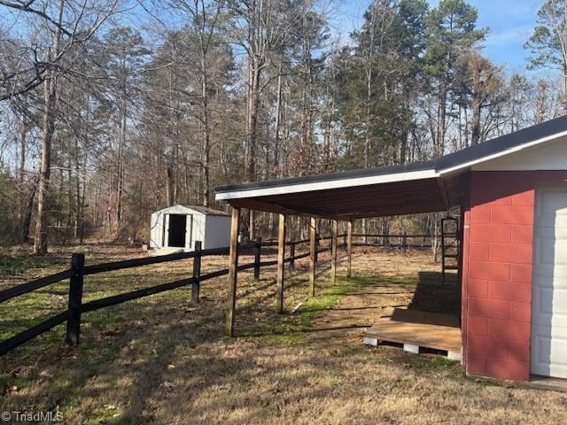 view of yard featuring a carport and a shed