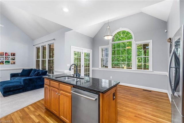 8300 Trottington Rd, Stokesdale, NC 27357 - kitchen with stainless steel appliances, vaulted ceiling, french doors, light wood-style floors, and open floor plan