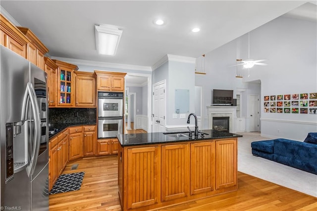 8300 Trottington Rd, Stokesdale, NC 27357 - kitchen featuring stainless steel appliances, open floor plan, light wood-style flooring, ornamental molding, and a ceiling fan
