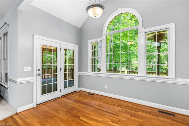 8300 Trottington Rd, Stokesdale, NC 27357 - unfurnished dining area featuring wood finished floors and vaulted ceiling