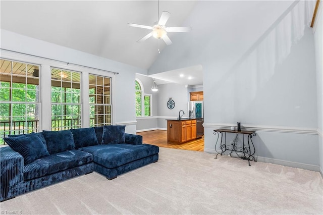 8300 Trottington Rd, Stokesdale, NC 27357 - living room featuring vaulted ceiling, ceiling fan, light colored carpet, and light wood-style flooring