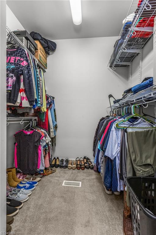 8300 Trottington Rd, Stokesdale, NC 27357 - walk in closet featuring carpet floors