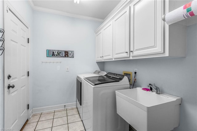 8300 Trottington Rd, Stokesdale, NC 27357 - laundry area with washing machine and dryer, cabinet space, crown molding, and light tile patterned floors