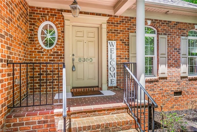 8300 Trottington Rd, Stokesdale, NC 27357 - view of exterior entry featuring brick siding and a porch