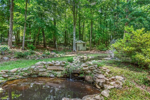 8300 Trottington Rd, Stokesdale, NC 27357 - view of yard with a shed and a wooded view