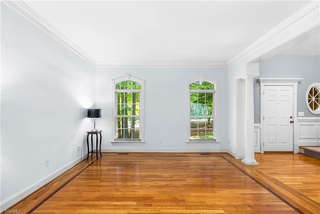 8300 Trottington Rd, Stokesdale, NC 27357 - unfurnished living room featuring ornate columns, plenty of natural light, wood finished floors, and ornamental molding
