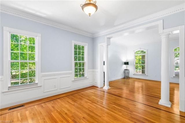 8300 Trottington Rd, Stokesdale, NC 27357 - unfurnished living room featuring ornate columns, wood finished floors, crown molding, and wainscoting