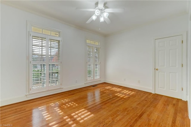 unfurnished room featuring crown molding, ceiling fan, and light hardwood / wood-style floors