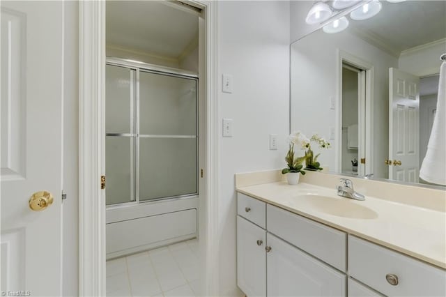 bathroom with vanity, combined bath / shower with glass door, and crown molding