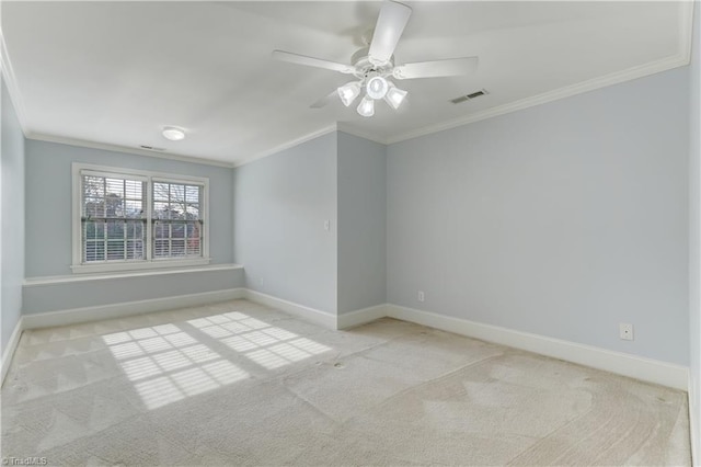 carpeted empty room featuring ceiling fan and ornamental molding