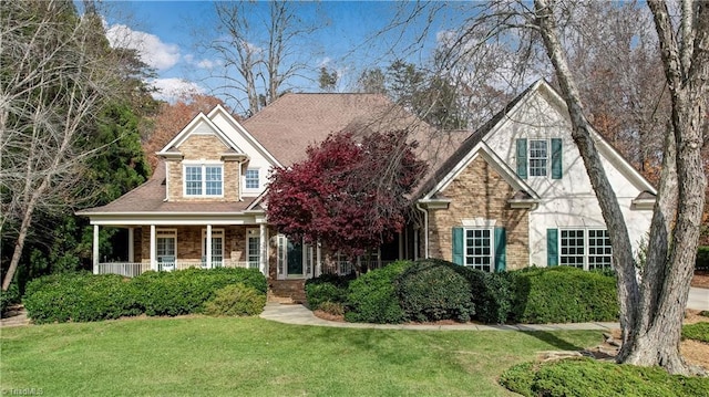 view of front of home with a porch and a front yard