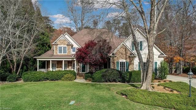 view of front of home with a porch and a front lawn