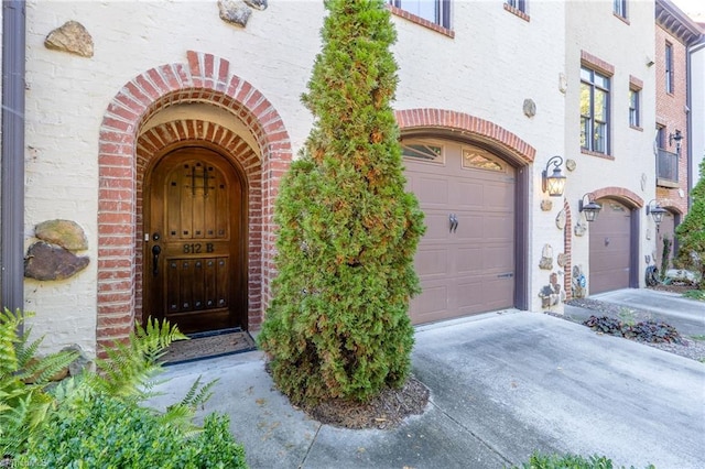 doorway to property with a garage