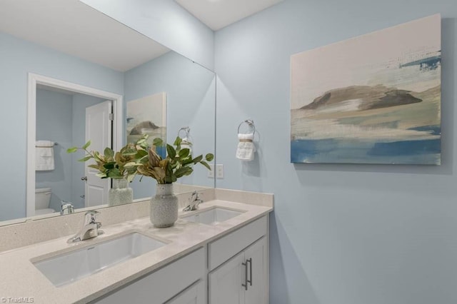 bathroom featuring vanity and toilet