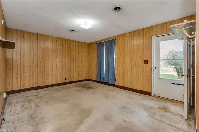 unfurnished room with wood walls