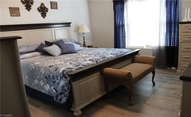 bedroom with wood finished floors