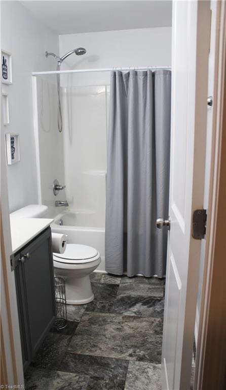 bathroom with toilet, shower / bath combo, and vanity