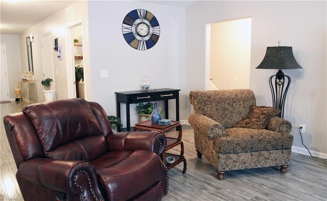 sitting room with wood finished floors and baseboards