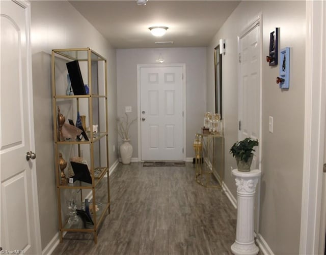 interior space with baseboards and wood finished floors