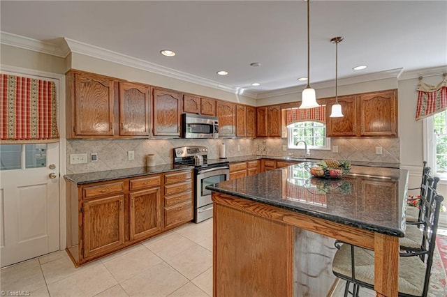 kitchen with a sink, brown cabinetry, and stainless steel appliances