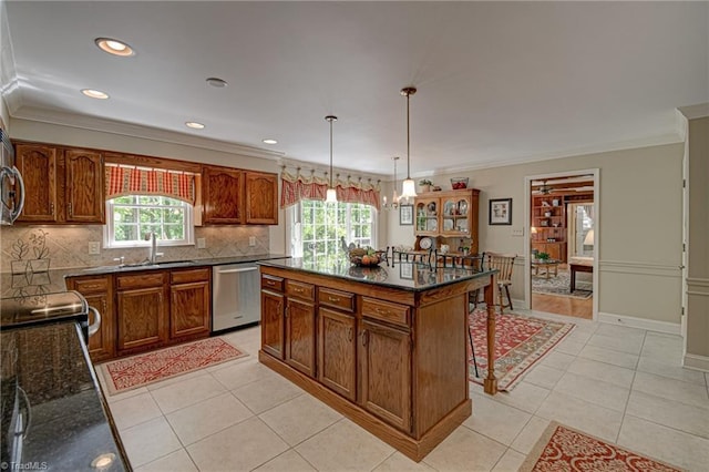 kitchen featuring stainless steel dishwasher, backsplash, crown molding, and a healthy amount of sunlight