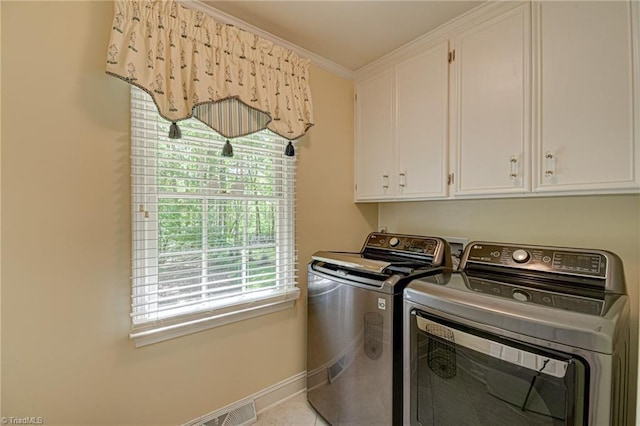 laundry area featuring visible vents, washing machine and clothes dryer, cabinet space, baseboards, and ornamental molding