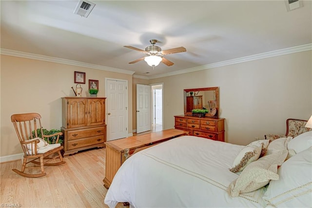 bedroom featuring crown molding, a ceiling fan, light wood finished floors, and visible vents