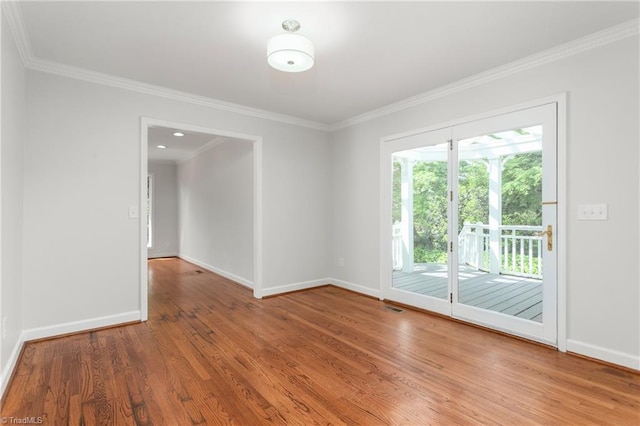 empty room with baseboards and wood finished floors