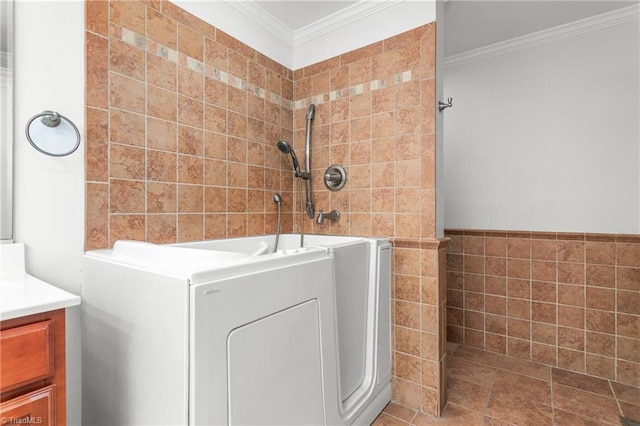 washroom with crown molding, laundry area, and tile walls