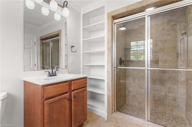 full bath featuring ornamental molding, built in shelves, a shower stall, and vanity