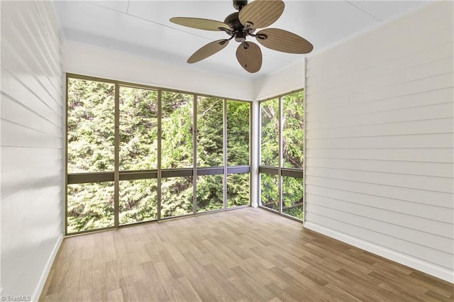 unfurnished sunroom with ceiling fan and a wealth of natural light