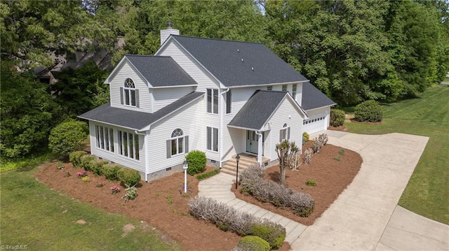 exterior space with a chimney, a garage, crawl space, a front yard, and concrete driveway