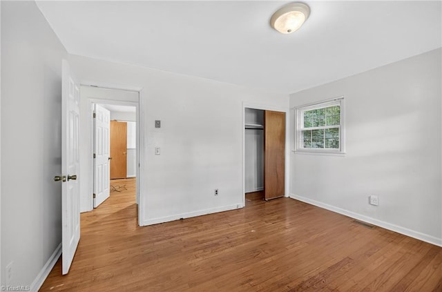 6006 Dehaven Rd, Pleasant Garden, NC 27313 - unfurnished bedroom with wood finished floors and a closet