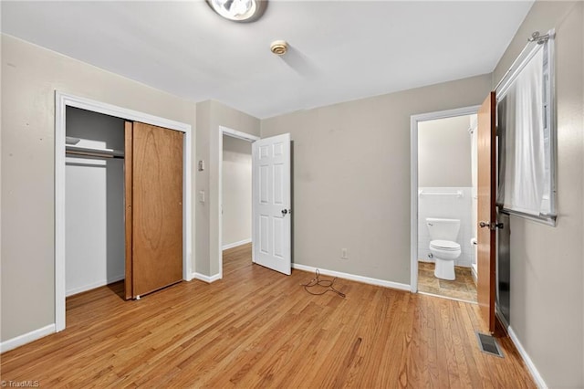 6006 Dehaven Rd, Pleasant Garden, NC 27313 - unfurnished bedroom with light wood finished floors, a closet, and ensuite bathroom