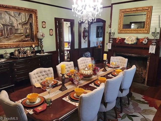 1715 Alfred Hartley Rd, Lenoir, NC 28645 - dining space with a chandelier, a fireplace, and wood finished floors
