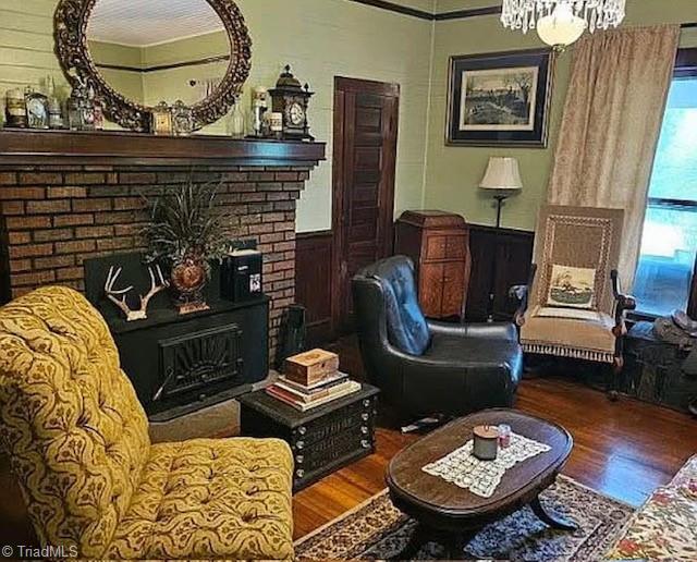 1715 Alfred Hartley Rd, Lenoir, NC 28645 - living area featuring wood finished floors, wainscoting, a chandelier, and a fireplace