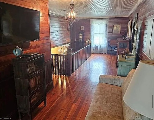 1715 Alfred Hartley Rd, Lenoir, NC 28645 - hallway featuring wood walls, a chandelier, hardwood / wood-style floors, crown molding, and an upstairs landing