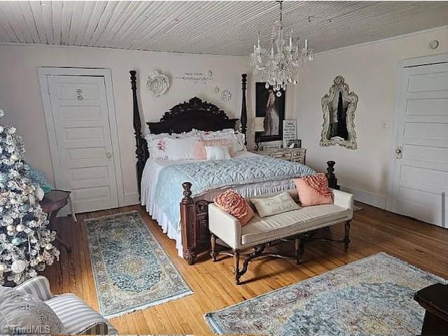 1715 Alfred Hartley Rd, Lenoir, NC 28645 - bedroom featuring a chandelier, wood finished floors, and baseboards