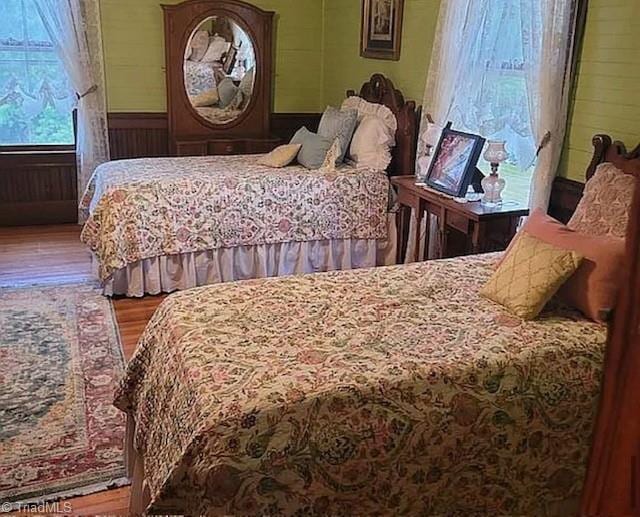 1715 Alfred Hartley Rd, Lenoir, NC 28645 - bedroom featuring wood finished floors, wooden walls, and a wainscoted wall