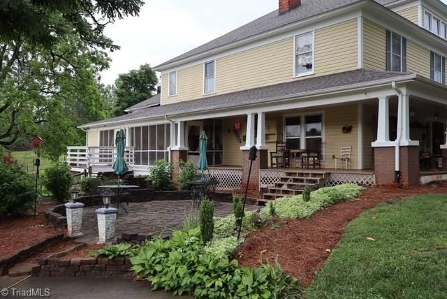 1715 Alfred Hartley Rd, Lenoir, NC 28645 - farmhouse-style home with a chimney and covered porch