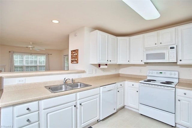 4712 Brighton Park Dr Unit 1B, Winston-Salem, NC 27103 - kitchen featuring white appliances, a sink, white cabinetry, ceiling fan, and a peninsula