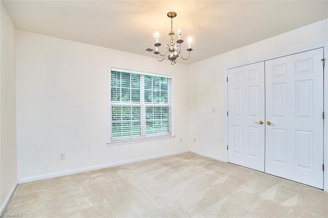 4712 Brighton Park Dr Unit 1B, Winston-Salem, NC 27103 - unfurnished bedroom with a chandelier, light carpet, and baseboards